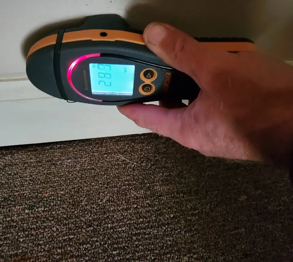 Moisture detection at baseboard during Storm Damage Restoration in Miami Shores